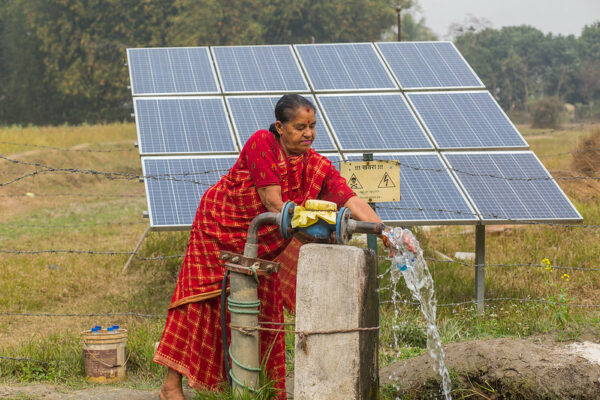 Nepalese farmer with her solar irrigation pump. ©Photo credit: Nabin Baral / IWM (CC BY-NC 2.0 DEED)