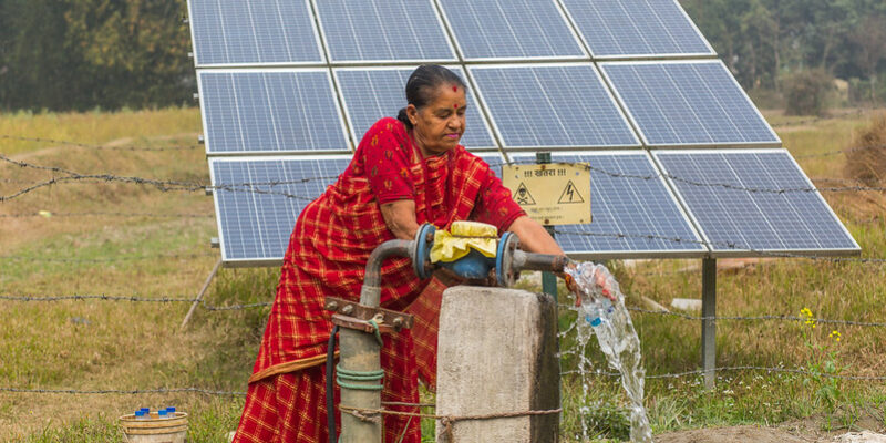 Nepalese farmer with her solar irrigation pump. ©Photo credit: Nabin Baral / IWM (CC BY-NC 2.0 DEED)