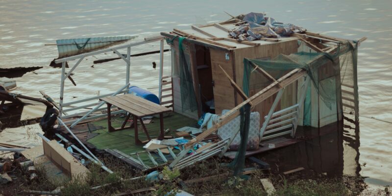 Boathouse wreckage after hurricane wind water pollution