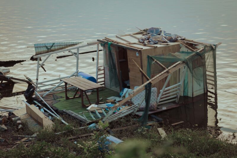 Boathouse wreckage after hurricane wind water pollution