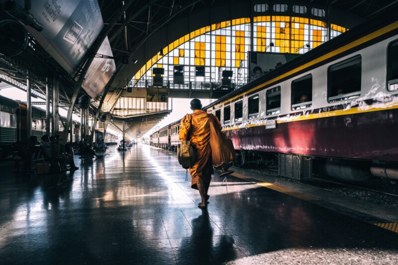 A monk walks through Bangkok’s old train station.